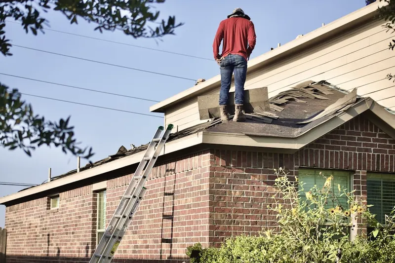 Professional roofer working on a residential roof in Covina